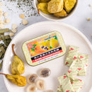 Some Prince of Peace Honey Loquat Candy - Fritillary Almond Pear Flavor candies, individual wraps, dried pear and a package in a white plate.