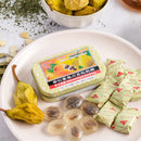 Some Prince of Peace Honey Loquat Candy with individual wraps, a package, and dried pear on a white plate.