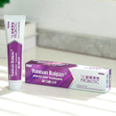 A package of Yunnan Baiyao JinKouJian Fresh Mint Toothpaste and a tube on the white countertop.