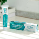 A package of Yunnan Baiyao JinKouJian Refreshing Lime Toothpaste and a tube on the white countertop.
