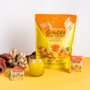A glass of cold Prince of Peace Instant Ginger Honey Crystals Turmeric with a package, gingers ,and sachets aside.