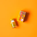 A box and a bottle of Trumpet Brand Seirogan TOI-A, 36 ct (Sugar Coated) on a yellow background.