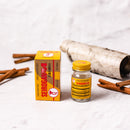 A box and a bottle of Trumpet Brand Seirogan TOI-A, 36 ct (Sugar Coated) in front of some cinnamon on a white background.