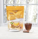A glass of Prince of Peace Instant Wild American Ginseng Tea with a package on a white table in front of a window.