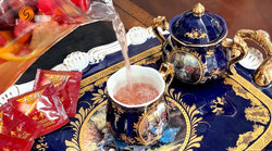 American Ginseng Fruit Tea in a mug with a teapot and tea bags aside.