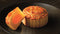 One and a cube of Wing Wah 2 Yolks White Lotus Seed Paste Mooncake on a plate.