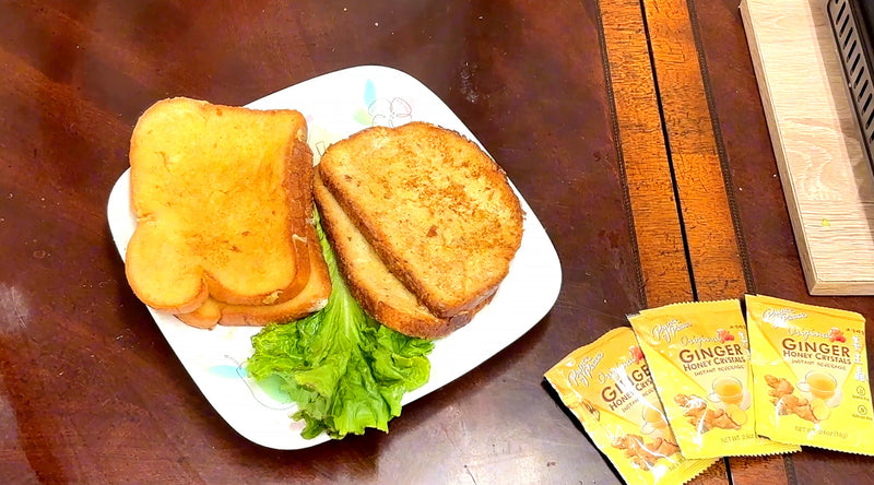 Ginger French Toast on a plate with some sachets of Ginger Honey Crystal aside.