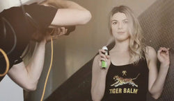 Kristin Allen is being photographed using Tiger Balm Active spray.