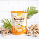 A package of Prince of Peace Ginger Hard Candy with some pieces, and gingers in front of a leaf.