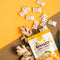 A package of Prince of Peace Ginger Hard Candy with gingers and pieces. on a brown and yellow background.
