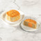 A Wing Wah 1 Yolk White Lotus Seed Paste Mooncake on a white tray and a half mooncake on another tray.