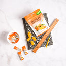 Ginger soft chews packaging with candies and stationery on a white background