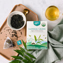 A package of Prince of Peace Imperial Green Organic Whole Leaf Tea, 10 tea bags with a cup of tea and tea leaves aside.