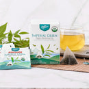 A package of Prince of Peace Imperial Green Organic Whole Leaf Tea, 10 tea bags with a cup of tea and tea bags.