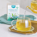 A package of Imperial Green Tea, A teapot is pouring tea into a glass cup.