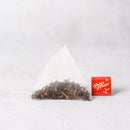 A Prince of Peace High Mountain Black Organic Whole Leaf Tea triangle tea bag.