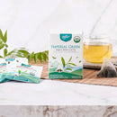 A package of Prince of Peace Imperial Green Organic Whole Leaf Tea, 10 tea bags with a cup of tea and tea bags.