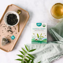 A package of Prince of Peace Imperial Green Organic Whole Leaf Tea, 10 tea bags with a cup of tea and tea leaves aside.