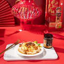 On Kee XO Sauce with Whole Abalone on noodles in a plate with a package aside on a red background.