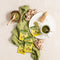 A cup of Prince of Peace Ginger Honey Crystals Matcha and Matcha powder with sachets and gingers on a tablecloth.