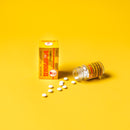 A box and a bottle Trumpet Brand Seirogan TOI-A with some pills aside on 
 yellow background. 