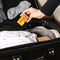 Putting a box of Trumpet Brand Seirogan TOI-A, 36 ct (Sugar Coated) in a luggage case with some stuff inside.