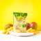 A package of Prince of Peace Ginger Candy (Chews) Mango with some mango slices on a plate in front of a yellow background.