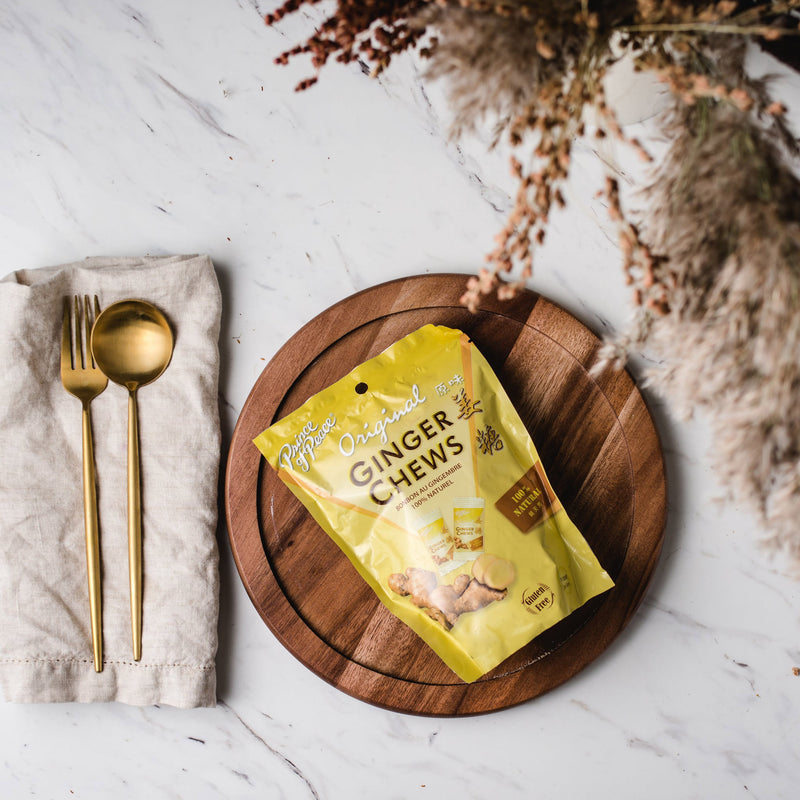 A package of Prince of Peace Ginger Candy (Chews), Original in a plate with a spoon, from aside.