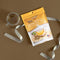 A glass of Prince of Peace Instant Wild American Ginseng Tea bag with a ribbon and package. 